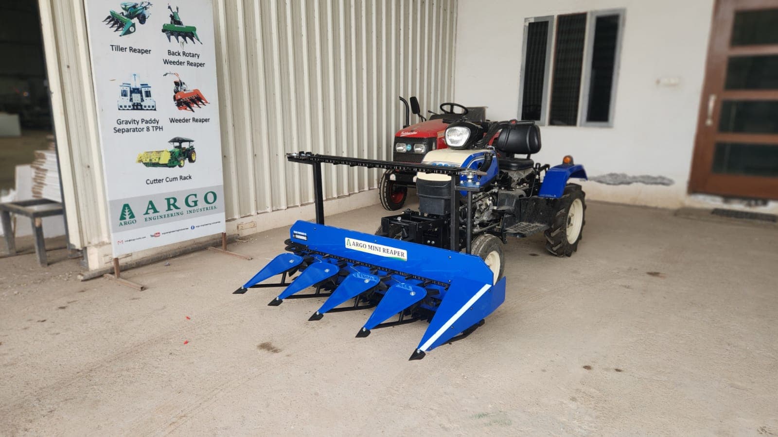Blue tractor-mounted reaper at dealer facility