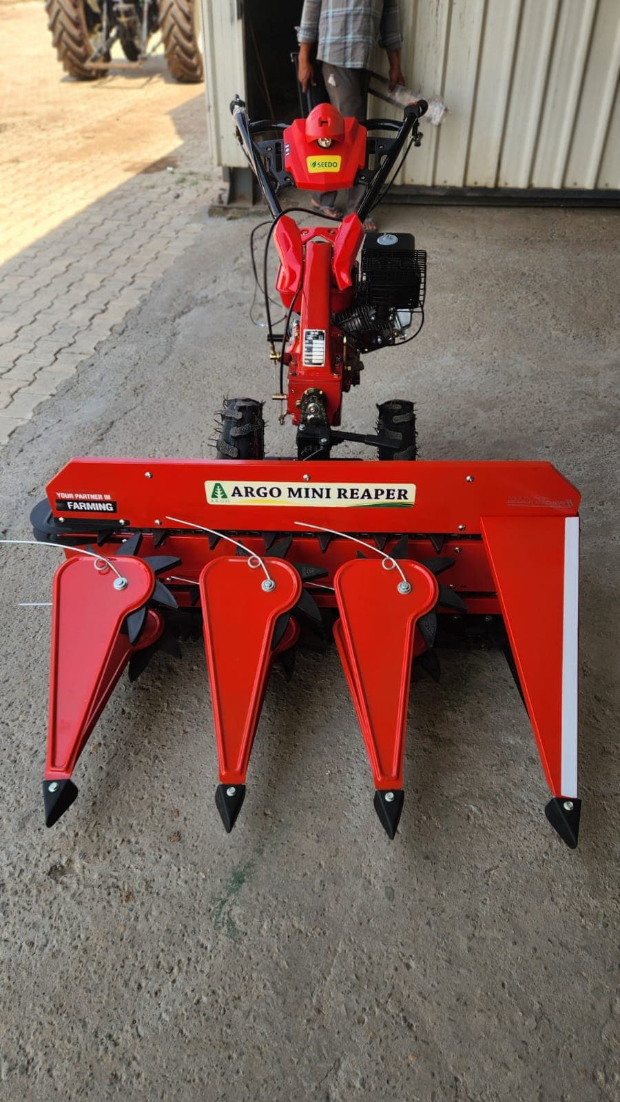 Red walk-behind reaper, side angle